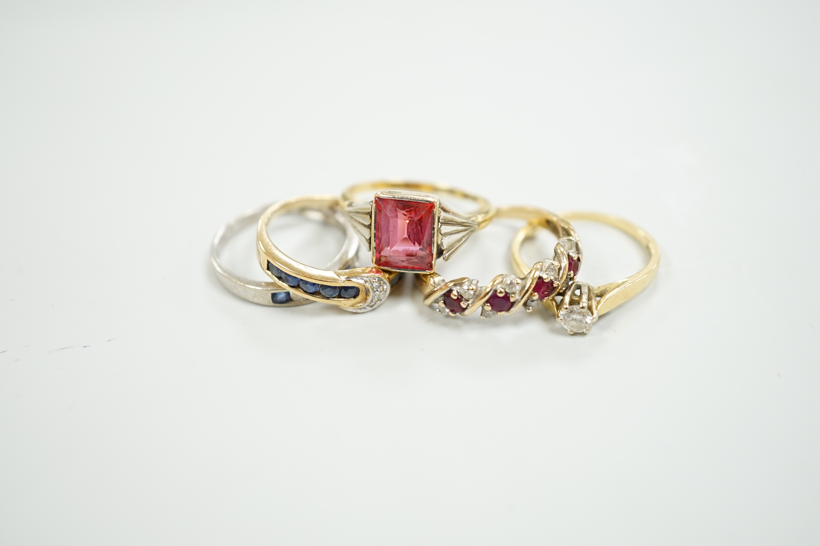 Three assorted 9ct gold and gem set rings, gross 6.7 grams, two 18ct and gem set rings including solitaire diamond and a 750 and gem set small pendant, gross 6.1 grams.